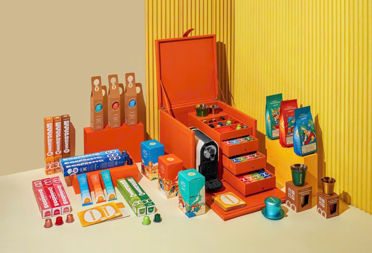 The Eggyolk family of products around an orange gift chest with a capsule machine