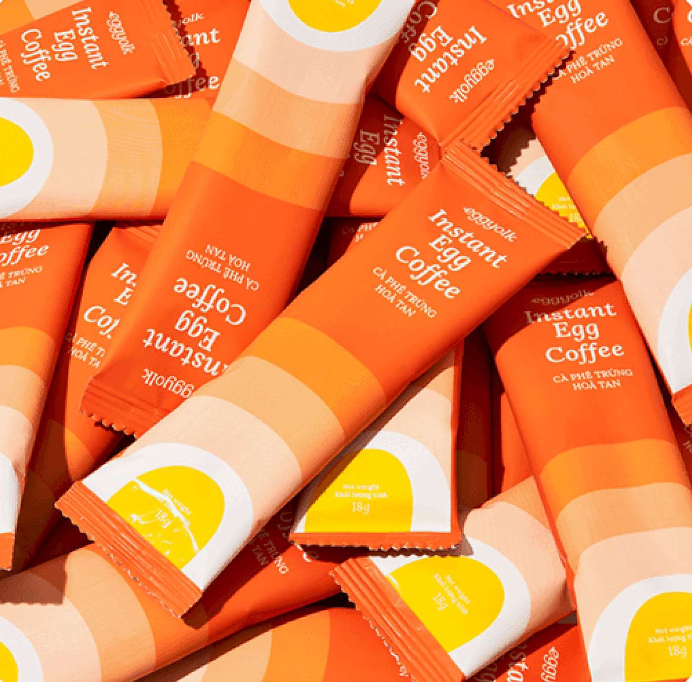 A pile of Eggyolk Instant Egg Coffee sachets